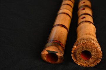 Shakuhachi flute, Shakuhachi is Japanese bamboo flute, on black background. © makoto photo