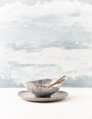 Traditional ceramic bowl on bright  background. Soft focus. Copy space. 