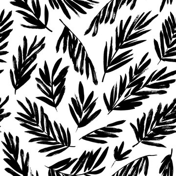 Palm leaves seamless pattern. Brush drawn palm branches silhouettes ornament. Sketch style tropical leaves drawn by brush. Abstract plant motif. Modern monochrome ornament. Vector botanical pattern.