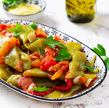 Homemade stewed green beans, tomatoes, garlic with olive oil. Zeytinyagli fasulye traditional food. Turkish cuisine.