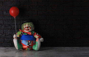 clown doll on a black background