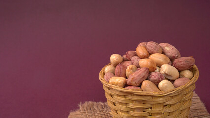 Close up of Salted Peanuts Indian namkeen (snacks) on a ceramic white bowl. Top view