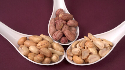 Close up of Salted Peanuts Indian namkeen (snacks) on a ceramic white bowl. Top view