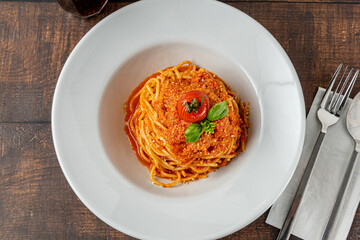 Pasta with cheese and tomato sauce on a white porcelain plate