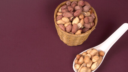 Close up of Salted Peanuts Indian namkeen (snacks) on a ceramic white bowl. Top view
