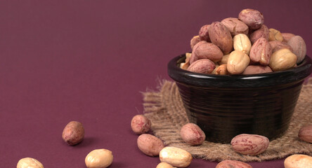 Fototapeta na wymiar Close up of Salted Peanuts Indian namkeen (snacks) on a ceramic white bowl. Top view