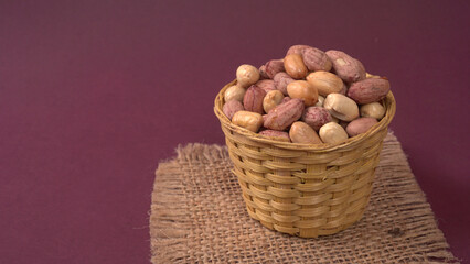 Close up of Salted Peanuts Indian namkeen (snacks) on a ceramic white bowl. Top view