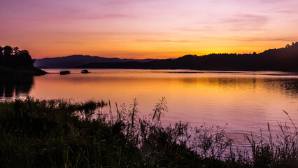 landscape sunset with Reservoir and raft house Thailand