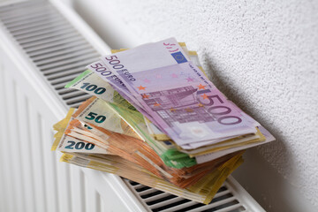 Euro banknotes heating a radiator.