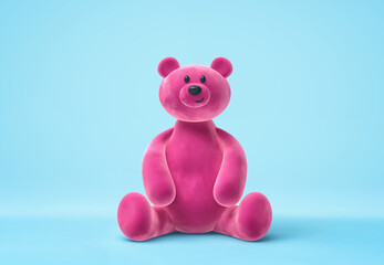 Pink smiling bear toy isolated on blue background. Clipping path included
