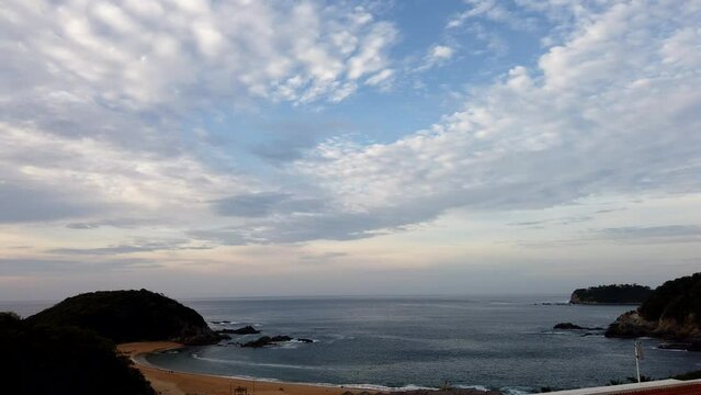 TIMELAPSE OF A BEACH, WE SEE THE CLOUDS MOVE BY DAY