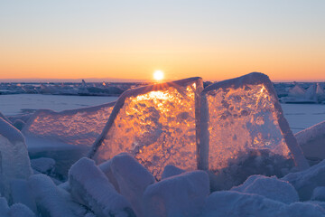 Winter sunrise at Lake Baikal, Russia. Blue ice at sunlight