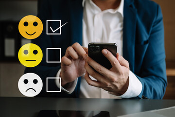 Smart man use smartphone and tablet choosing happy smile face icon. feedback rating and positive customer review experience, mental health assessment. world mental health day concept..