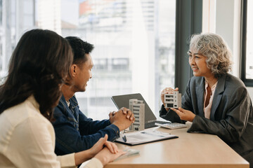 Sales giving male customer signing sales contract, Asian woman and man doing business in office, business concept and contract signing.