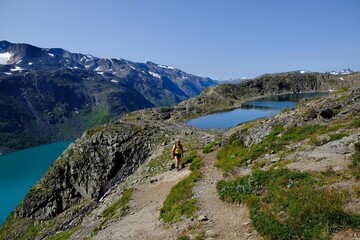 Scenic Besseggen trail in Jotunheimen, Norway - the most beautiful trekking trail in Norway. Silhouettes of hiking tourists on trail.	
