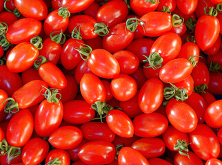 Bright red cherry tomatoes top view close up, natural vegan food background.