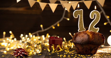 Number 72 golden festive burning candles in a cake, wooden holiday background. seventy-two years since the birth. the concept of celebrating a birthday, anniversary, holiday. Banner.