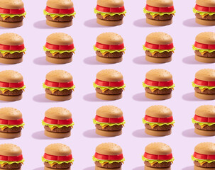 Fototapeta na wymiar Seamless pattern of plastic childrens toy burger with salad, tomato, meat with on yellow. Concept of harmful artificial food. Unhealthy. Not organic. Top view. Food background.