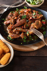 Stew chicken marinated with harissa sauce and cooked with vegetables. 