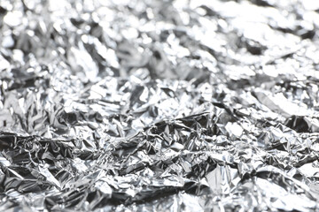 Crumpled silver foil as background, closeup view