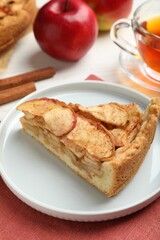 Slice of delicious apple pie served on table, closeup