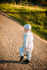 Cute and handsome baby boy 1-2 years old exploring nature in summer, having fun