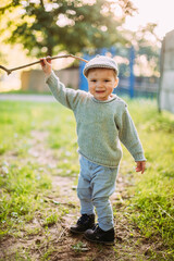 Cute and handsome baby boy 1-2 years old exploring nature in summer, having fun