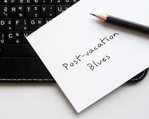 Paper note on keyboard with handwritten text Post-vacation Blues - Post-Holiday Blues or post-travel depression or sad mood persons returning home from long trip experience, affect performance at work