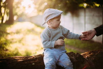 Cute and handsome baby boy 1-2 years old exploring nature in summer, having fun