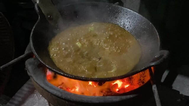 Someone is cooking javanese goat curry also known as Tongseng Kambing. This dish uses Gulai soup with sweet soy sauce and some cabbage. Tongseng and Sate Klathak usually found in Imogiri, Yogyakarta.
