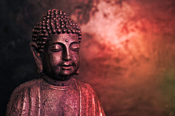 Meditating Buddha Statue isolated on dark background. Copy space. - 560359007