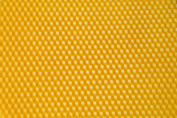 Natural beeswax sheet as background, top view