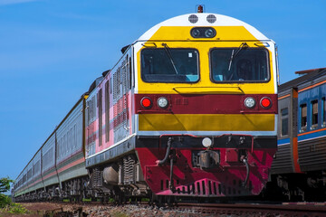 Fototapeta premium Passenger train by diesel locomotive on the railway.