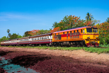 Passenger train by diesel locomotive on the railway.