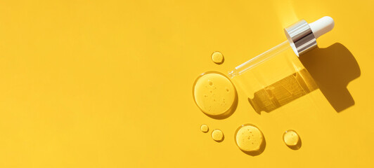 pipette drop of serum test on a yellow background sun glare