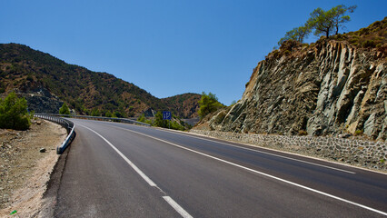 The highway connecting the Aegean and the Mediterranean. Asphalt road winding between mountains.