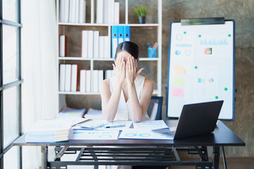 Portrait of sme business owner, woman using computer and financial statements Anxious expression on...