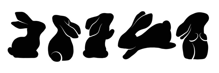 Vector set of black silhouettes of rabbits in various poses. Shadows of hares isolated from background. © veleri_kz