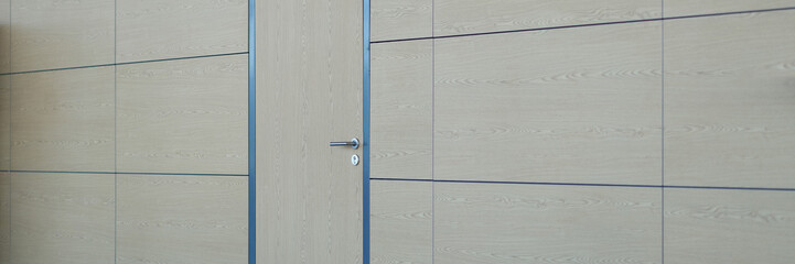 Light brown beige wall with door in business center
