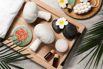 Obraz na płótnie Canvas Flat lay composition with herbal massage bags and other spa products on grey table