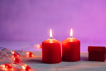 Beautiful composition with red candles on the white wooden table. Romantic love image