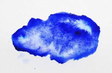 Blot of blue ink on white background, top view
