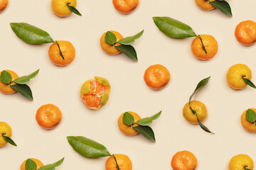 Orange yellow juicy tangerines with green leaves, whole and peeled on neutral beige background, geometric pattern. Citrus fruits mandarins, healthy fruits food concept, creative photo, top view