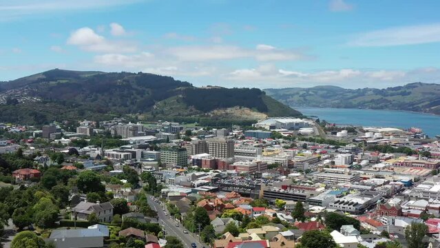 Wide aerial panorama over Dunedin city in New Zealand on Pacific coast 4k.
