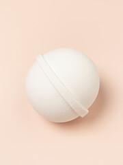 White bath bomb on pink or peachy background