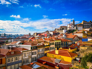 View of the rooftops of the city of Porto, Portugal. Tiled roofs just sparkle against the sky.