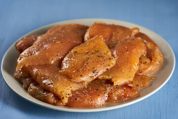 Seasoned chicken breast fillets on a plate