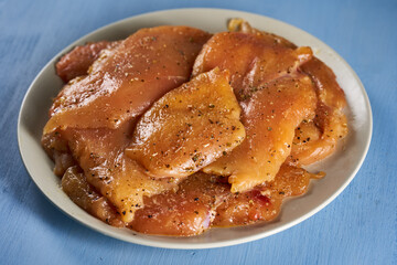 Seasoned chicken breast fillets on a plate
