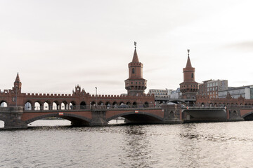 Fototapeta na wymiar Berlin Oberbaumbrücke bridge connecting two parts of the city over the river, tourist attraction - tourism concept