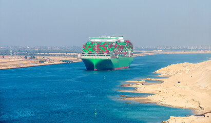 Large container ship,  passing through the Suez Canal in Egypt.
